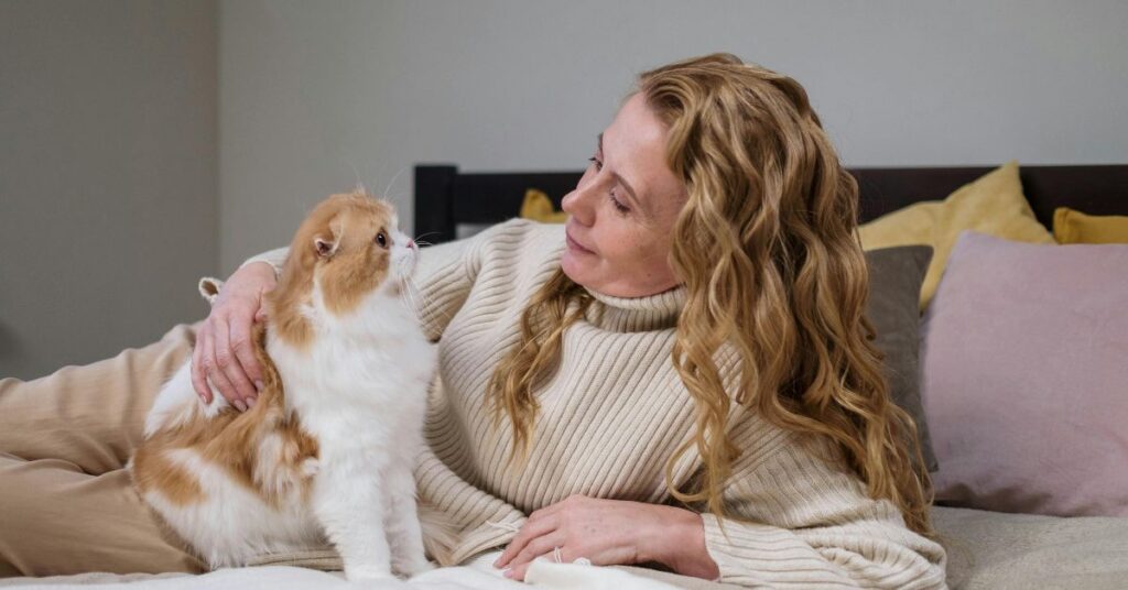 Women with white and orange cat
